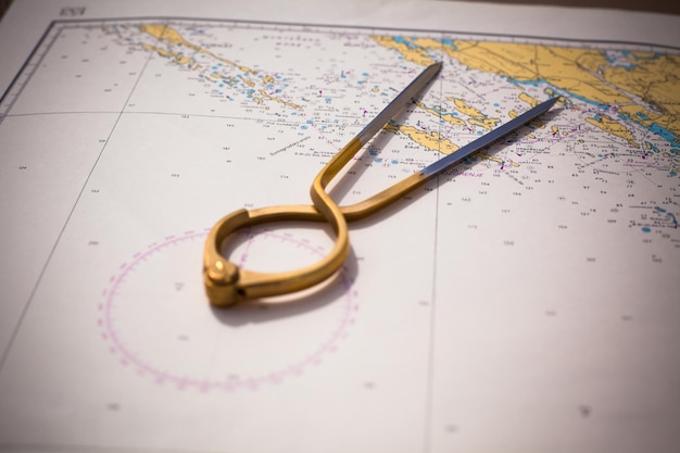 Pair of compasses for navigation on a sea map