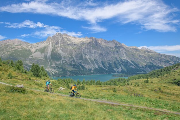 Pair of cyclists during a mountain bike excursion on the Alps