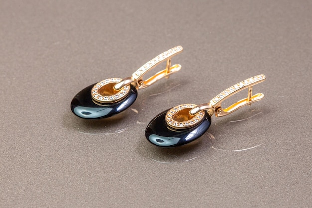 A pair of earrings with diamonds and a black diamond.