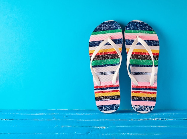 Pair of female beach slippers on a blue background