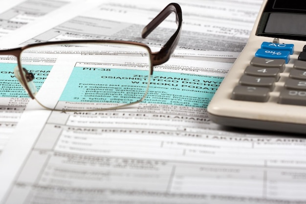 A pair of glasses sit on top of a form that says " pitch ".