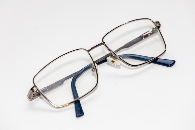 A pair of glasses with blue and silver frames on a white background.