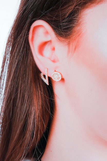 A pair of gold earrings with a diamond design.