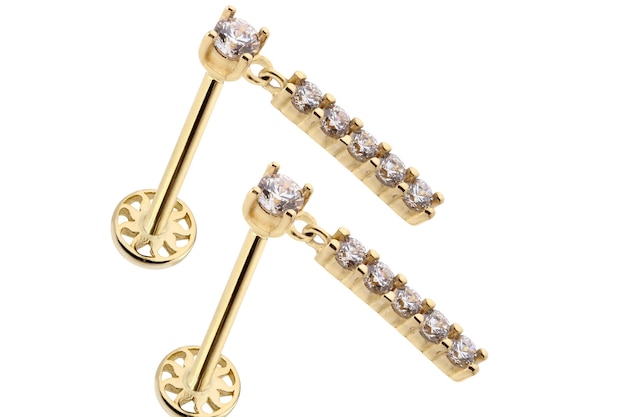A pair of gold earrings with diamonds on the side.