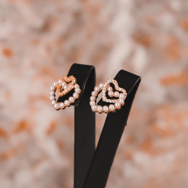 A pair of gold earrings with the word love on the front.