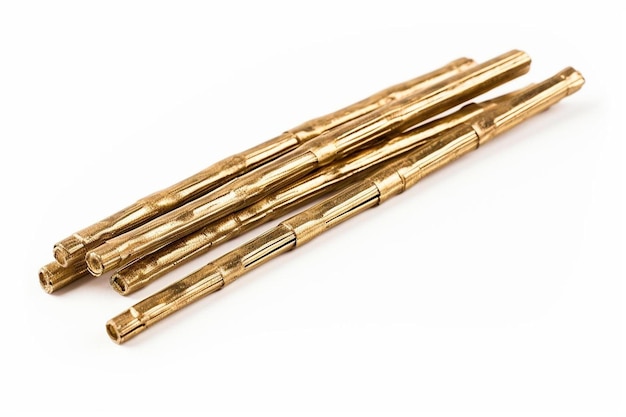 a pair of gold sticks with a white background.