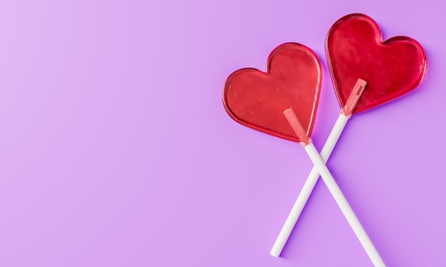 Pair of heartshaped lollipops on a purple background with space for text