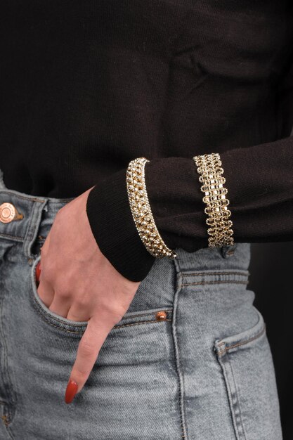 Photo a pair of jeans with a gold studded top and a black shirt