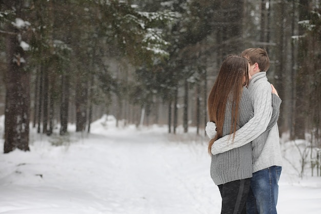 A pair of lovers on a date winter afternoon in a snow blizzard