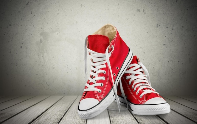 Pair of new red sneakers isolated on background.