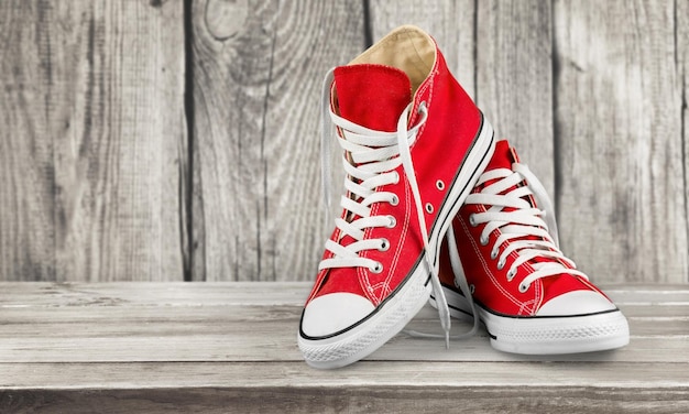 Pair of new red sneakers isolated on background.