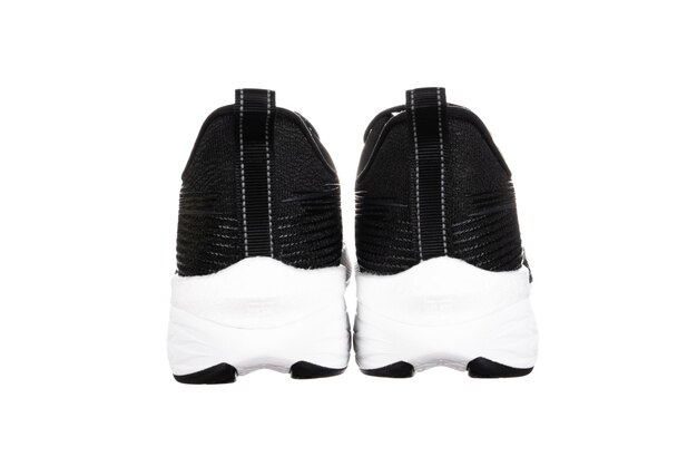 Pair of new unbranded black sport running shoes or sneakers isolated on white background with clipping path