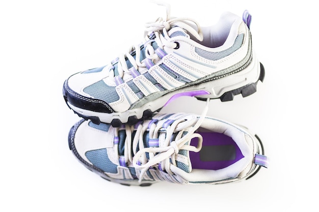 Pair of new womens hiking shoes on a white background.