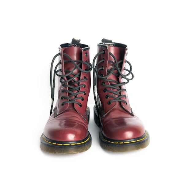 Pair of old burgundy boots isolated on white background