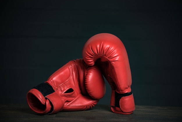 Pair of red boxing gloves on black 