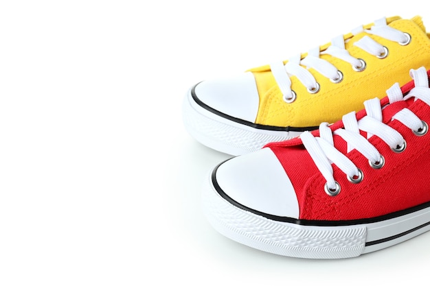 Pair of red and yellow sneakers isolated on white background