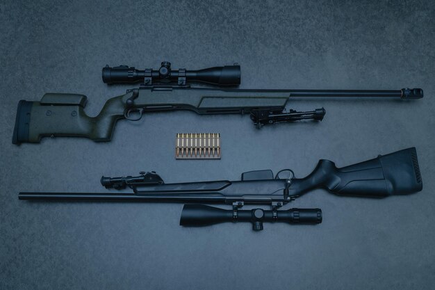 A pair of rifle and a bullet are next to each other.