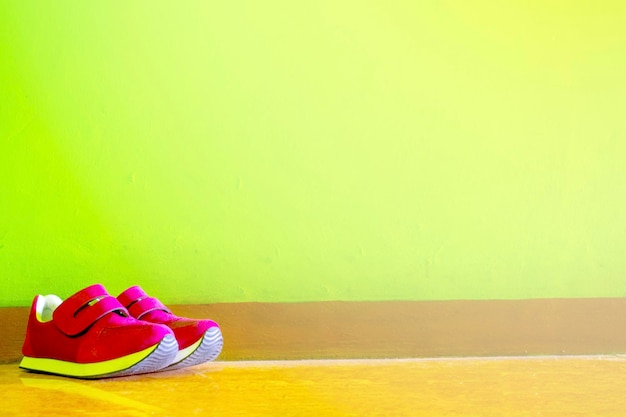 A pair of shoes leaning against the wall