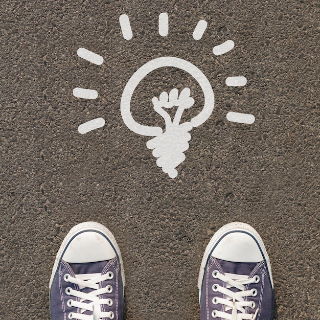 Pair of shoes standing on a road with icon