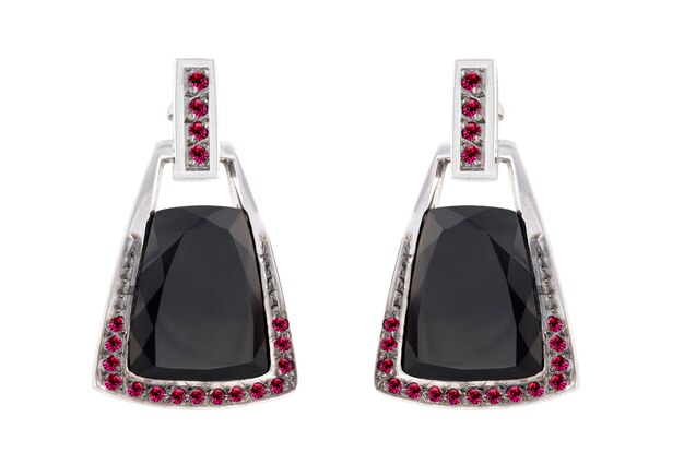 Pair of silver earrings with black stone isolated on white surface