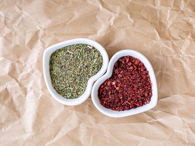 Pair of spices in heart shaped bowls. Macro