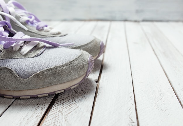 Pair of sport shoes on white wooden background