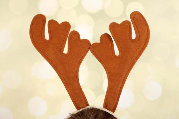 Pair of toy reindeer horns on bright background