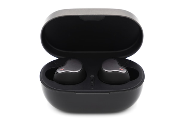 Pair of true wireless earbuds in case isolated on white background