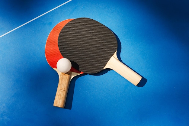Pair of two table tennis or ping pong paddles or rackets with table tennis ball