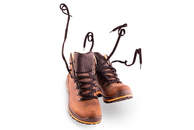 Pair of walking man brown hiking boots isolate on a white\
background