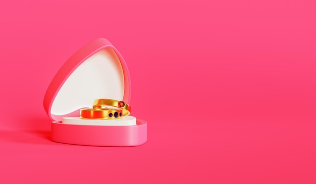 분홍색 배경과 빈 공간이 있는 사랑 모양의 상자에 놓인 한 쌍의 결혼 반지