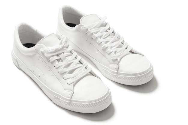 Pair of white leather trainers with a shadow on white background