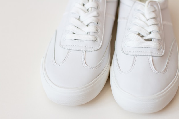 pair of white sneakers shoes on white