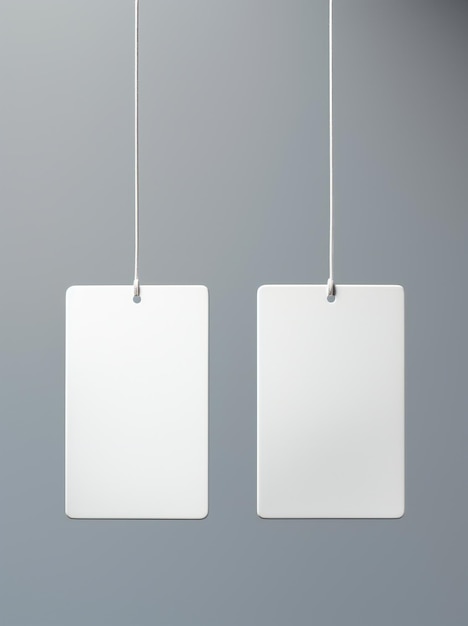 a pair of white tags hanging from a gray background.