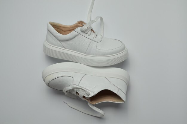 a pair of white trainers for women