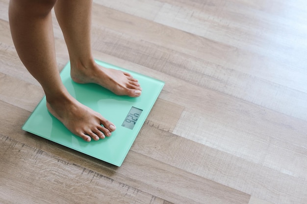 A pair of woman feet standing on a digital scale