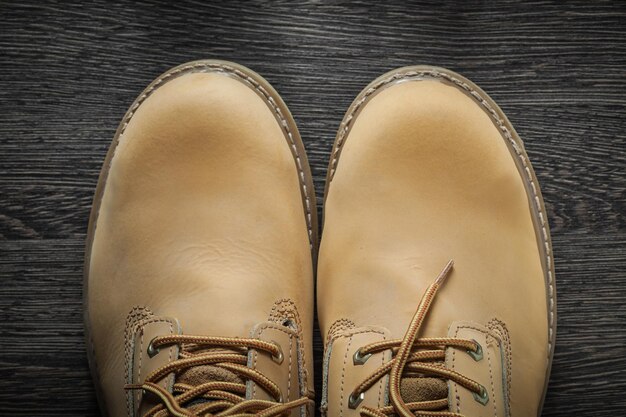 Pair of working boots on vintage wooden board