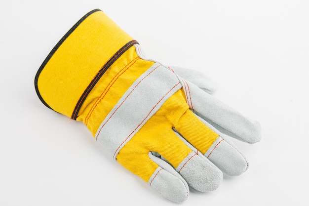 Pair of yellow construction gloves on a white insulated background