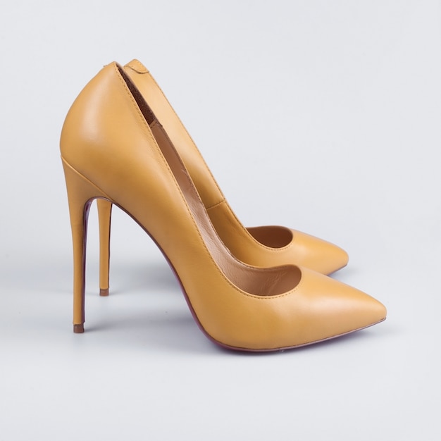 Pair of yellow women's heel shoes over