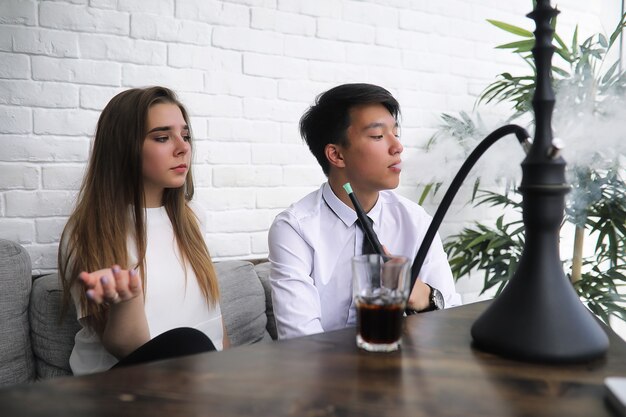 A pair of young people talking at the office table