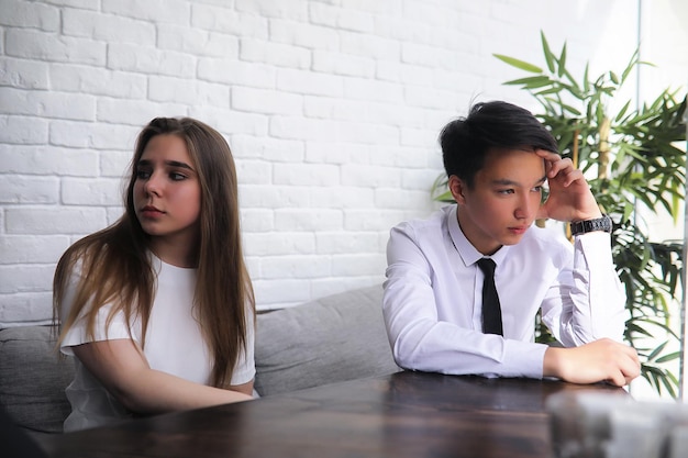 A pair of young people talking at the office