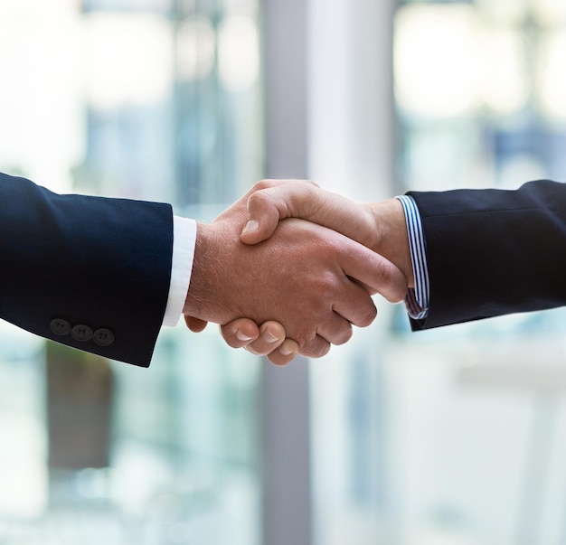 Pairing up with a trustworthy business associate Cropped shot of two businessmen shaking hands