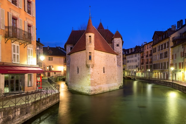 The Palais de l'Isle and Thiou river during morning blue hour in old city of Annecy, Venice of the Alps, France