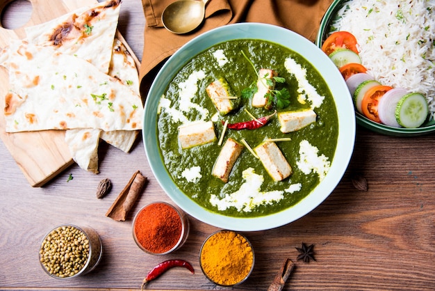 Palak Paneer Masala is a popular North Indian recipe for lunch dinner made using cottage cheese in green spinach curry. usually served with Rice and chapati naan. selective focus