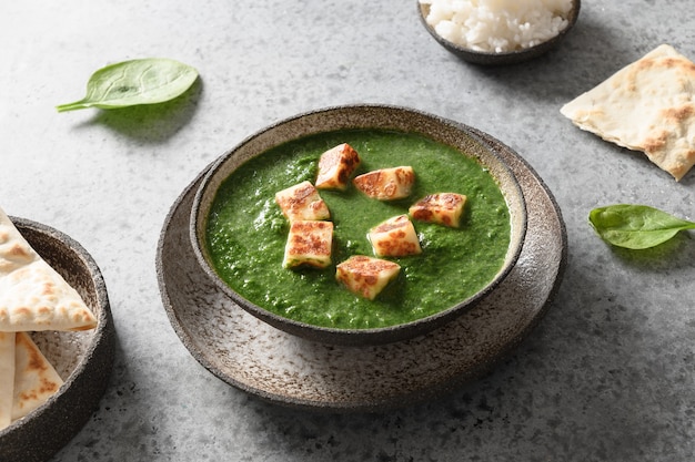 Palak paneer served basmati rice on grey