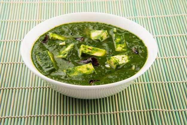 Palak paneer or Spinach and Cottage cheese curry is a healthy main course recipe in India, served in a bowl, isolated. selective focus