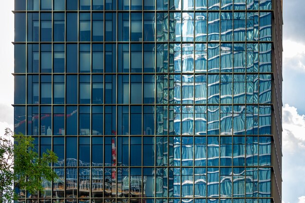 Photo palazzo lombardia reflected into a nearby building in milan italy