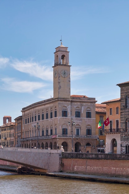 The Palazzo Pretorio and its clock tower next to the Logge Dei Banchi in Pisa Italy