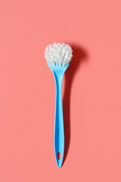 Pale blue brush for washing dishes lying 