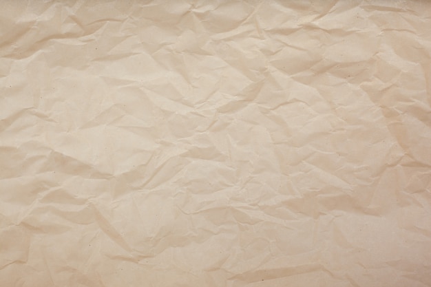 Pale brown crumpled paper texture background. 